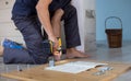 Man assembling furniture at home using a cordless screwdriver Royalty Free Stock Photo
