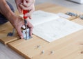 Man assembling furniture at home using screwdriver Royalty Free Stock Photo