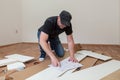 Man dressed casual assembling furniture in new house. Carpenter repair and assembling furniture at home