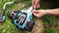 A man assembling parts of the string trimmer. Royalty Free Stock Photo