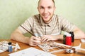 Man assembling plastic airplane model