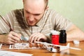 Man assembling plastic airplane model