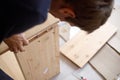 Man assembling wooden furniture at home, close up image Royalty Free Stock Photo