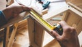 Man assembly wooden furniture,fixing or repairing house with tape