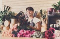 Man assistant in flower shop delivery make bouquet