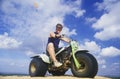 A man astride a 3-wheeled recreational vehicle in Little Sahara State Park, Oklahoma