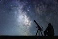 Man with astronomy telescope looking at the stars.