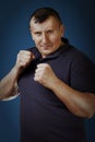 The man the athlete clenched fists. Boxer`s stance. Studio shooting