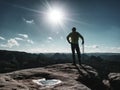 Man athlete runner with trekking poles running rocky trail