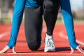 Man athlete on the starting line of a running track at the stadium, close up. Royalty Free Stock Photo
