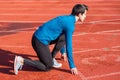 Man athlete on the starting line of a running track at the stadium. Royalty Free Stock Photo