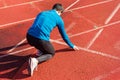 Man athlete on the starting line of a running track at the stadium. Royalty Free Stock Photo