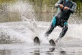 man athlete waterskiing behind motorboat on lake