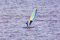 A man is an athlete windsurfing on the Volga River in the summer evening Royalty Free Stock Photo