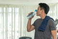 Man athletes drinking water from bottle in his hand with copy space. Concept exercise and healthy