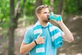 Man with athletic appearance holds bottle with water. Sport and healthy lifestyle concept. Athlete drink water after Royalty Free Stock Photo