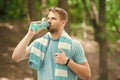 Man with athletic appearance holds bottle with water. Sport and healthy lifestyle concept. Athlete drink water after Royalty Free Stock Photo