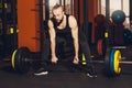 A man of athletic build is preparing to perform an exercise with a barbell Royalty Free Stock Photo