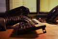 Man attacker hacker in black gloves on his hands working on a compu
