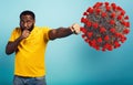 Man attacks with a punch the coronavirus. Blue background