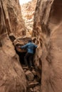 Man Attempts to Climb Over A Boulder Jam In Cotttonwood Canyon Royalty Free Stock Photo