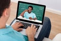 Man attending online math's lecture at home Royalty Free Stock Photo