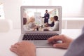 Man attending online video conference via modern laptop at table, closeup Royalty Free Stock Photo