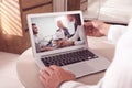 Man attending online video conference via modern laptop at table, closeup Royalty Free Stock Photo