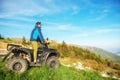 Man on the ATV Quad Bike on the mountains road. Royalty Free Stock Photo