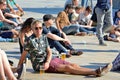 A man from the audience watches a concert and have a beer sitting in the floor Royalty Free Stock Photo