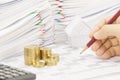 Man is auditing account with pencil and step gold coins Royalty Free Stock Photo