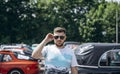 Man at auto show in summer day