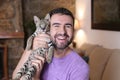 Man with baby Savannah F1 exotic cat