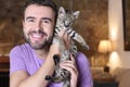 Man with baby Savannah F1 exotic cat