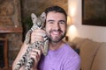 Man with baby Savannah F1 exotic cat