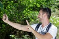 man with backback making victory sign for selfie Royalty Free Stock Photo