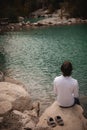 Man on the background of a mountain lake, tranquility and unity with nature in Turkey. authentic