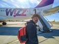 A man on the background of the plane WIZZ AIR airline at the international airport in Warsaw, Poland