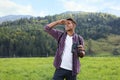 Man with backpack and binoculars in mountains Royalty Free Stock Photo