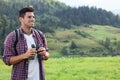 Man with backpack and binoculars in mountains Royalty Free Stock Photo