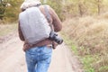 Man with a backpack and camera going to forest Royalty Free Stock Photo