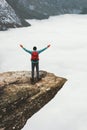 Man with backpack hiker on Trolltunga rocky cliff edge Royalty Free Stock Photo