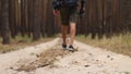 Man with backpack while hiking in the forest or mountains. Narrow focus