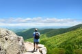 Man with backpack hiking in mountains on a summer vacation trip. Royalty Free Stock Photo