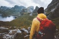 Man with backpack hiking in mountains travel survival alone in wilderness of Norway Royalty Free Stock Photo