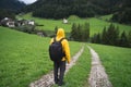 A Man with backpack on hiking trail to St. Johann church in Val di Funes valley, Dolomites, Italy, Europe Royalty Free Stock Photo