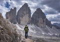 Man hiking with view at the Three Peaks in the European Dolomite Alps, South Tyrol Italy