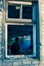 Man with backpack in ruined destroyed old building window frame Royalty Free Stock Photo