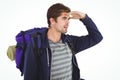 Man with backpack shielding eyes