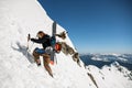 Man with backpack and ski equipment climbing at snowy ridge